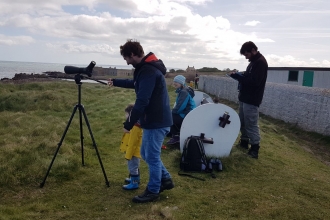 Volunteers using telescope