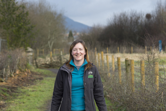 Deborah with a wheelbarrow on a nature reserve