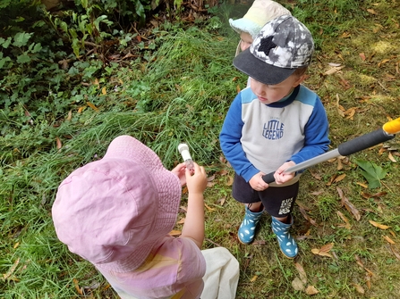 Showing the bug to their friend