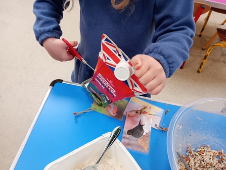 Make bird feeders from milk carton boxes