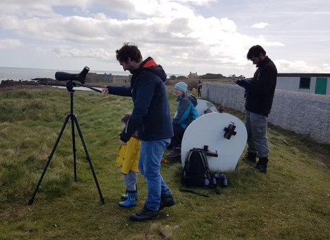 Volunteers using telescope